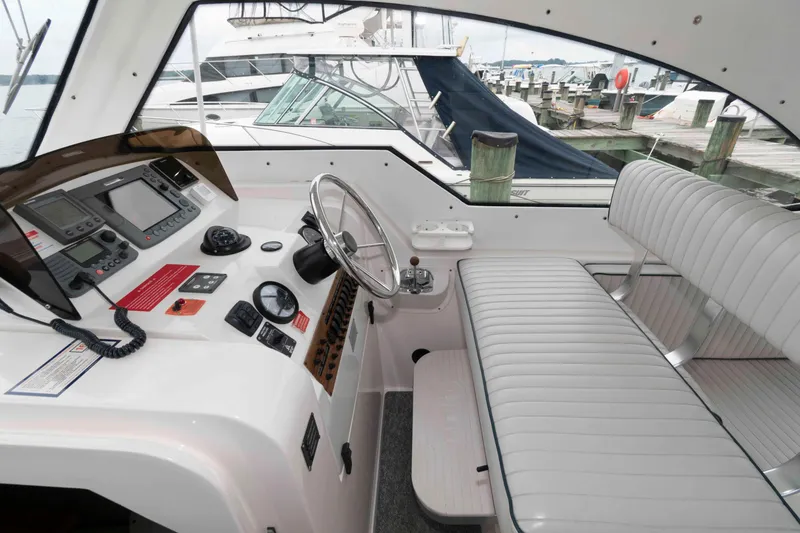 Slide: The Image of 2002 Mainship Pilot 34 Sedan helm with steering wheel and navigation equipment. - 11