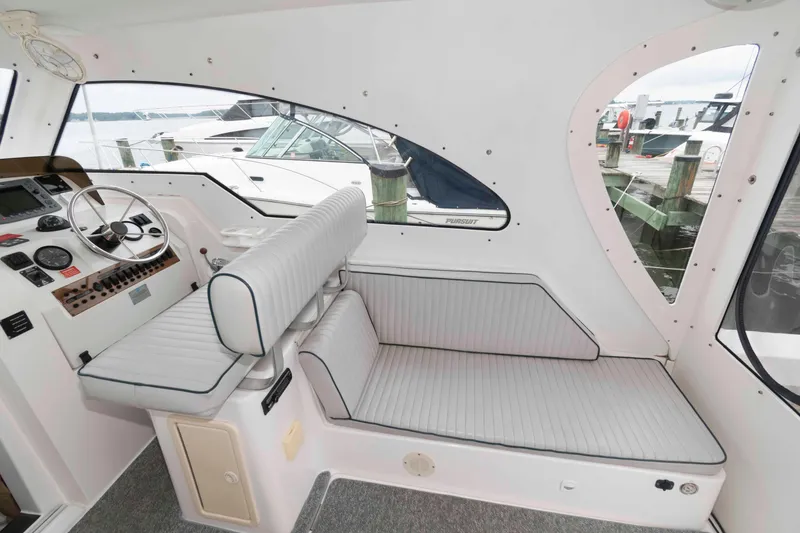 Slide: The Image of 2002 Mainship Pilot 34 Sedan interior with helm and seating area. - 14