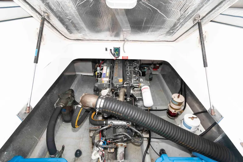 Slide: The Image of Engine compartment of 2002 Mainship Pilot 34 Sedan, showcasing mechanical components and layout. - 22