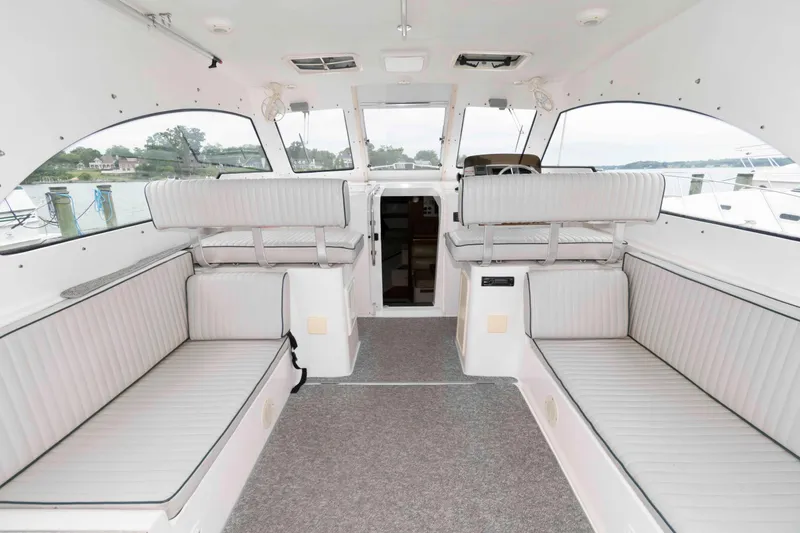 Slide: The Image of 2002 Mainship Pilot 34 Sedan interior with spacious seating and panoramic windows. - 9