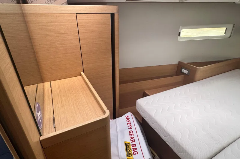Slide: The Image of Interior cabin of 2020 Jeanneau Sun Odyssey 410 with wooden furniture and mattress. - 16