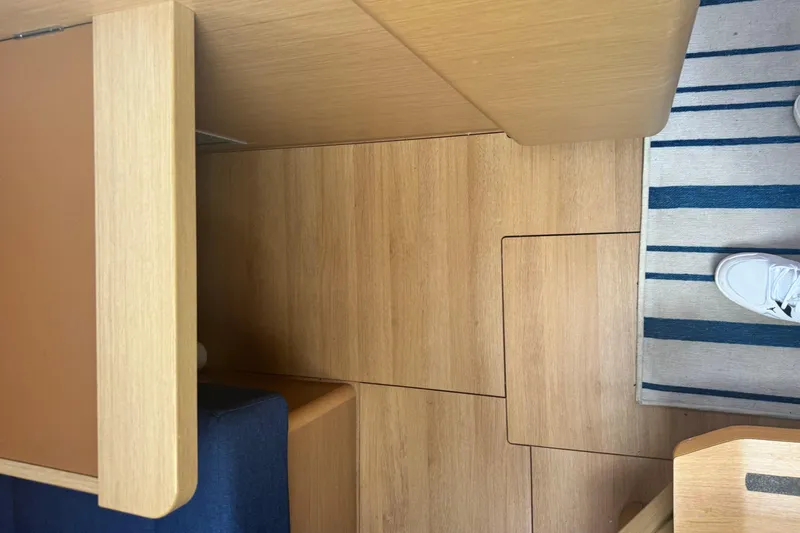 Slide: The Image of Interior view of 2020 Jeanneau Sun Odyssey 410 with wooden flooring and striped rug. - 18