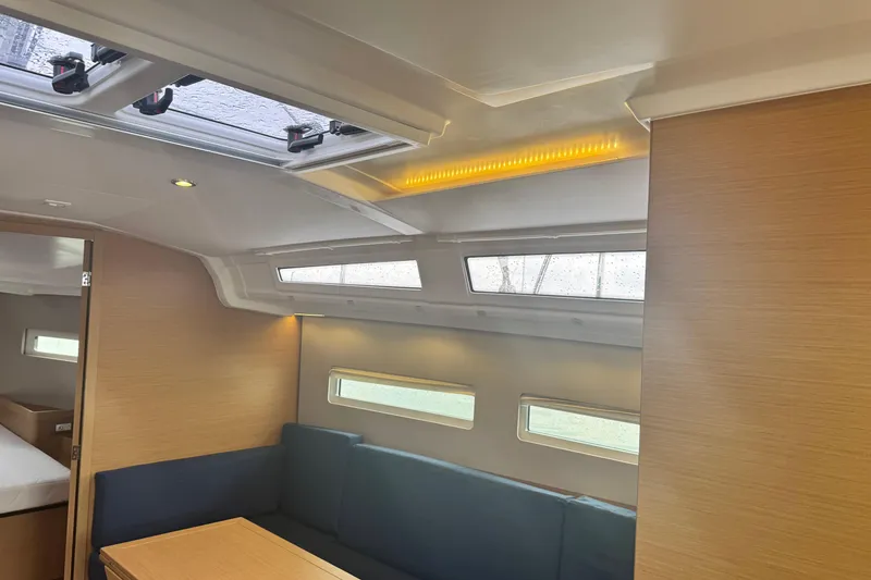 Slide: The Image of Interior of 2020 Jeanneau Sun Odyssey 410 yacht with modern seating and natural light. - 19
