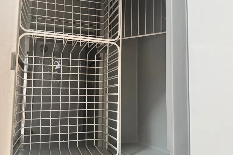 Slide: The Image of Empty refrigerator compartment in Jeanneau Sun Odyssey 410 yacht, 2020 model. - 24