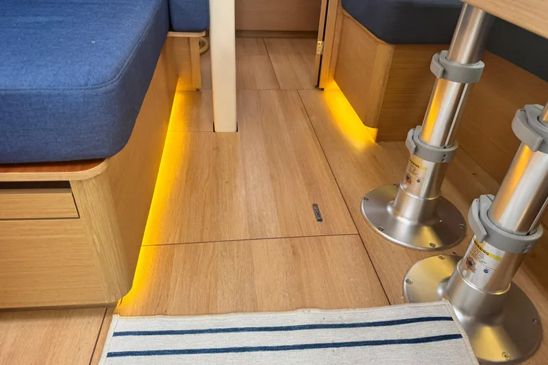 Slide: The Image of Interior of 2020 Jeanneau Sun Odyssey 410 with wooden flooring and ambient lighting. - 26