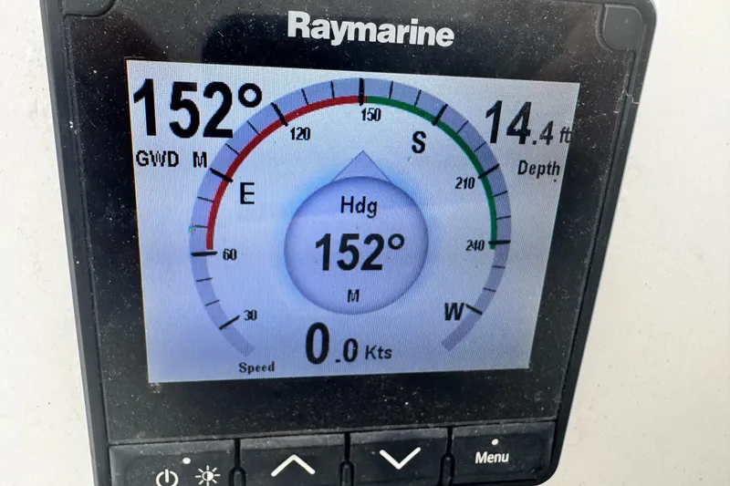 Slide: The Image of Raymarine display on Jeanneau Sun Odyssey 410, showing heading 152°, depth 14.4 ft. - 31