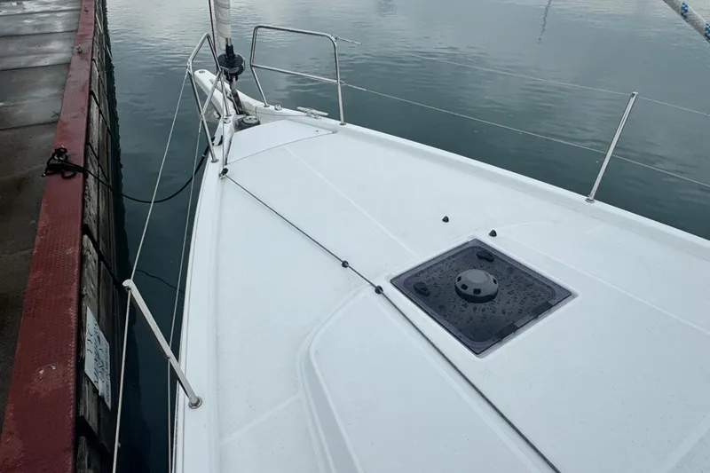 Slide: The Image of 2020 Jeanneau Sun Odyssey 410 sailboat docked, showing sleek deck design. - 4