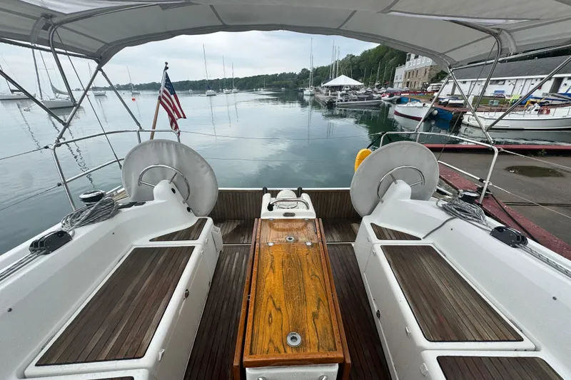 Slide: The Image of Cockpit view of 2020 Jeanneau Sun Odyssey 410 sailboat docked at a marina. - 6