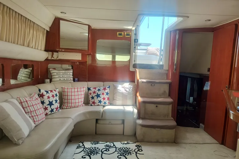 Slide: The Image of Interior of 1997 Sea Ray 420 Aft Cabin with cozy seating and nautical decor. - 10