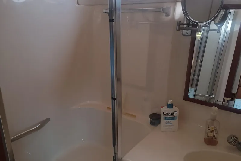 Slide: The Image of Bathroom interior of 1997 Sea Ray 420 Aft Cabin with shower and toiletries. - 18