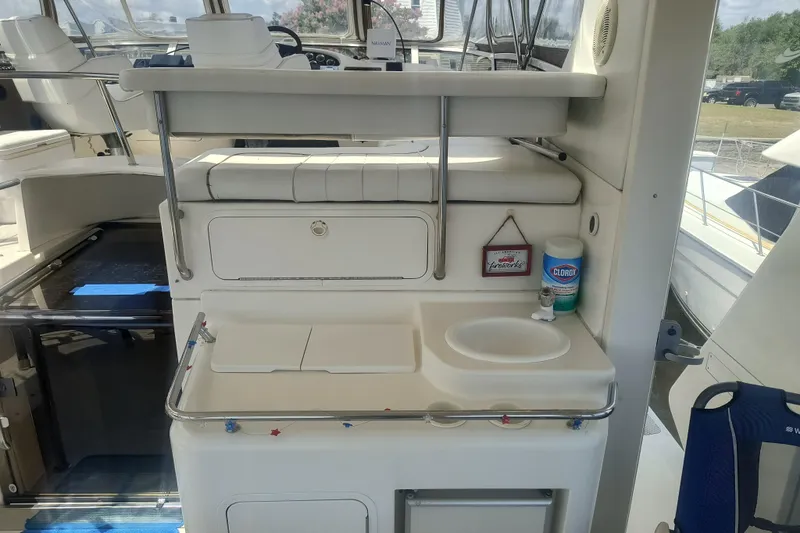 Slide: The Image of 1997 Sea Ray 420 Aft Cabin yacht interior with sink and seating area. - 6