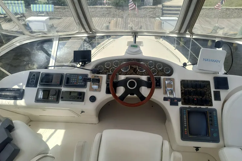 Slide: The Image of Cockpit of 1997 Sea Ray 420 Aft Cabin yacht with navigation instruments and steering wheel. - 7