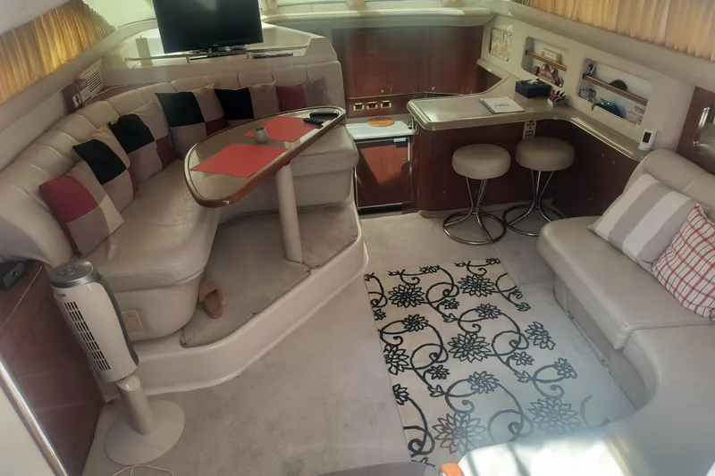 Slide: The Image of Interior of a 1997 Sea Ray 420 Aft Cabin with cozy seating and modern decor. - 9
