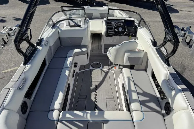 Slide: The Image of 2021 Moomba Max boat interior with spacious seating and modern dashboard. - 11