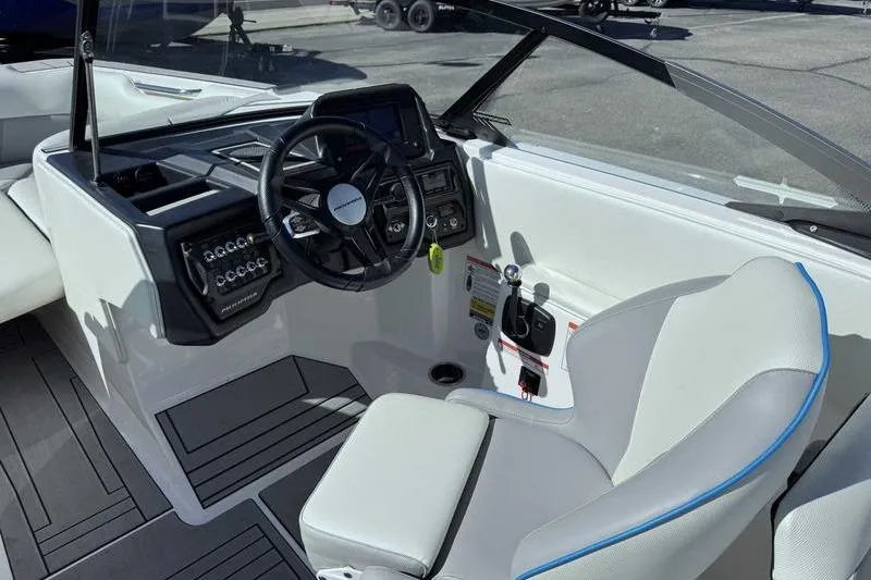 Slide: The Image of 2021 Moomba Max boat interior with steering wheel and control panel. - 14