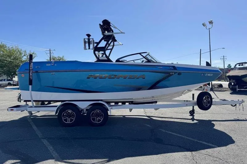 Slide: The Image of 2021 Moomba Max boat on trailer in parking lot, side view. - 5