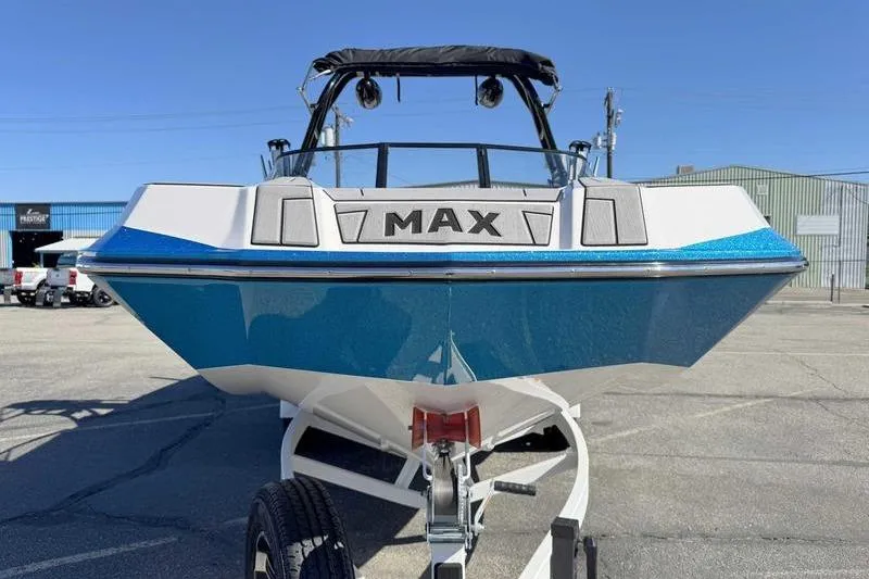 Slide: The Image of 2021 Moomba Max boat on trailer, blue and white design, parked outdoors. - 8