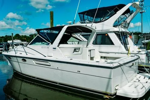 Slide: The Image of 2001 Tiara Yachts 3100 Open docked, featuring sleek design and spacious deck. - 0