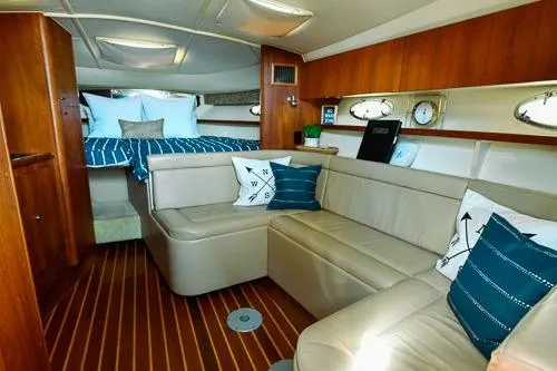 Slide: The Image of 2001 Tiara Yachts 3100 Open interior with cozy seating and nautical decor. - 11