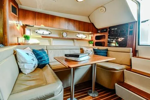 Slide: The Image of 2001 Tiara Yachts 3100 Open interior with cozy seating and wooden accents. - 12