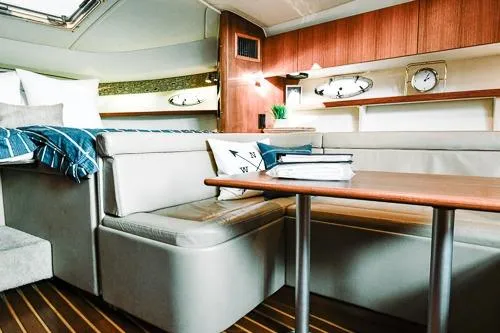 Slide: The Image of 2001 Tiara Yachts 3100 Open interior with cozy seating and wooden accents. - 13