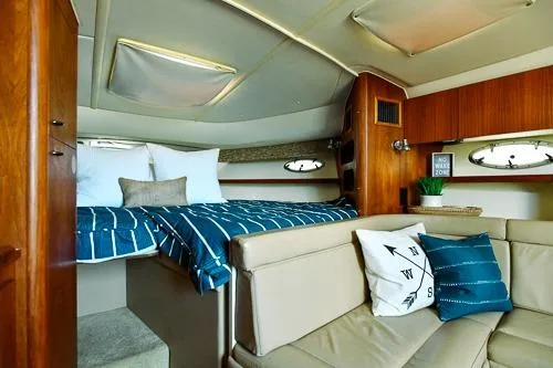 Slide: The Image of 2001 Tiara Yachts 3100 Open cabin interior with cozy bed and seating area. - 15