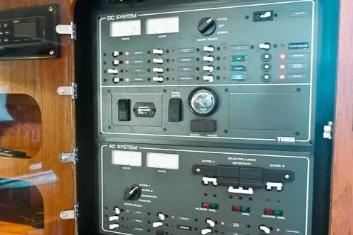 Slide: The Image of Control panel of a 2001 Tiara Yachts 3100 Open, featuring DC and AC systems. - 19