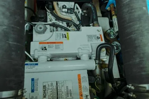 Slide: The Image of Engine compartment of a 2001 Tiara Yachts 3100 Open, featuring Kohler components. - 22