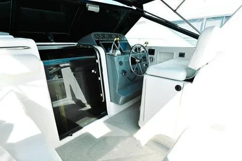 Slide: The Image of 2001 Tiara Yachts 3100 Open cockpit with steering wheel and control panel. - 3
