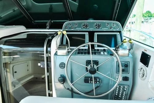 Slide: The Image of 2001 Tiara Yachts 3100 Open helm with steering wheel and control panel. - 6