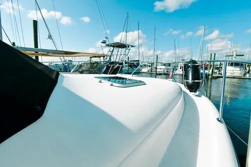 Slide: The Image of 2001 Tiara Yachts 3100 Open docked at a marina under a clear blue sky. - 7