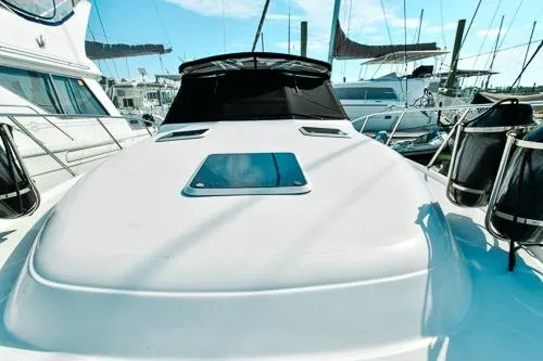 Slide: The Image of 2001 Tiara Yachts 3100 Open docked, showcasing sleek design and spacious deck. - 8