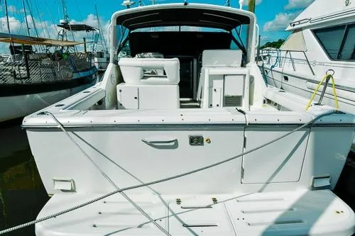 Slide: The Image of 2001 Tiara Yachts 3100 Open docked, showcasing spacious deck and seating area. - 9