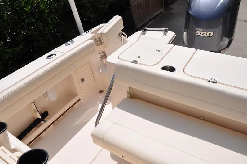 Slide: The Image of 2021 Grady-White Fisherman 236 boat interior with Yamaha 300 engine, featuring seating and storage. - 11