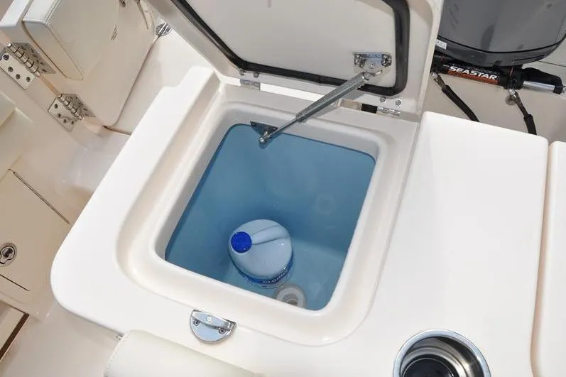 Slide: The Image of Livewell compartment on 2021 Grady-White Fisherman 236 boat with a gallon jug inside. - 13