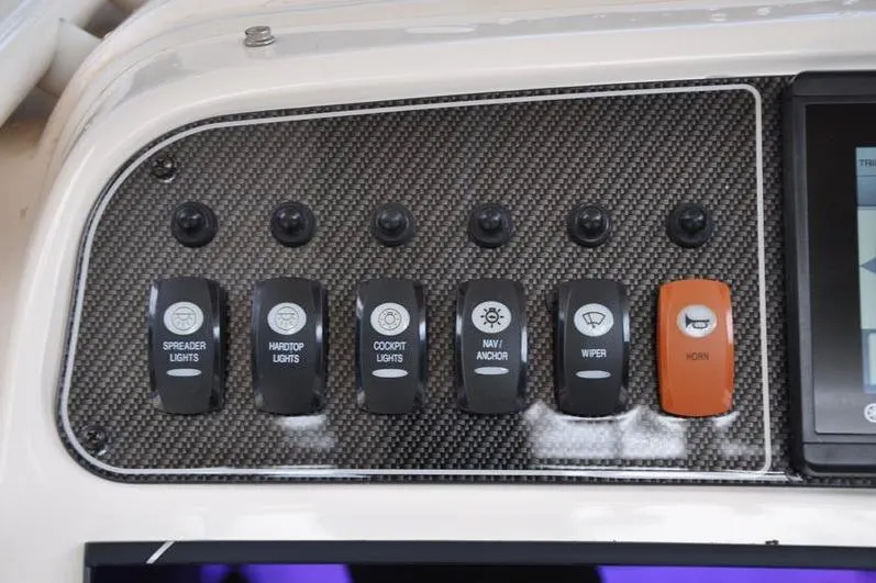 Slide: The Image of Control panel of 2021 Grady-White Fisherman 236 boat with labeled switches. - 18