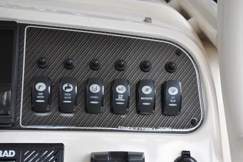 Slide: The Image of Control panel of 2021 Grady-White Fisherman 236 boat with labeled switches. - 19
