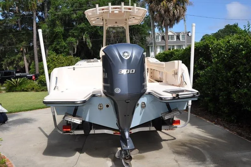 Slide: The Image of 2021 Grady-White Fisherman 236 boat with Yamaha 300 engine, parked in driveway. - 2