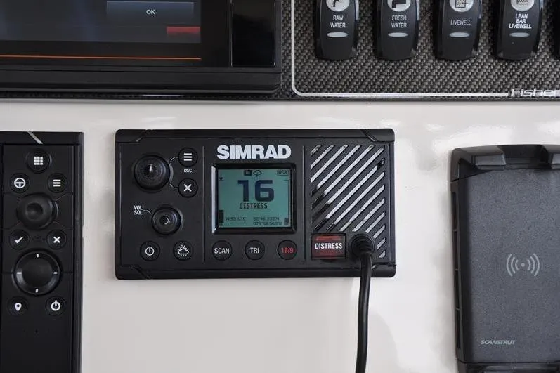 Slide: The Image of Simrad marine radio on Grady-White Fisherman 236 dashboard, displaying channel 16 distress signal. - 22