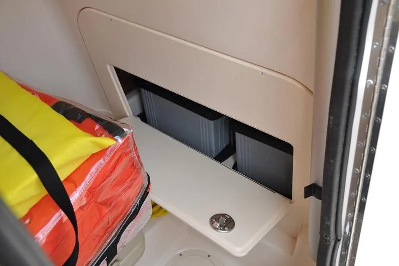 Slide: The Image of Storage compartment in 2021 Grady-White Fisherman 236 boat with safety gear. - 27