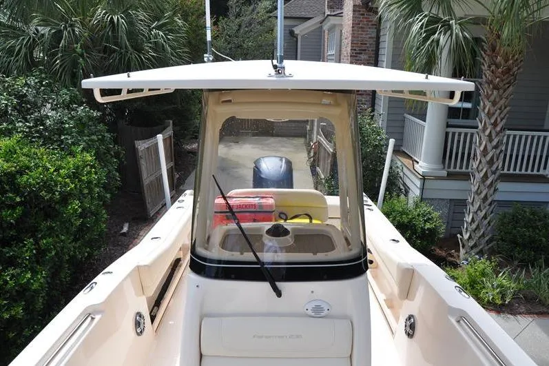 Slide: The Image of 2021 Grady-White Fisherman 236 boat, view from helm, surrounded by lush greenery. - 31