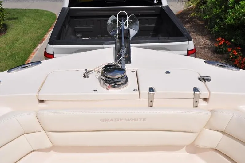 Slide: The Image of 2021 Grady-White Fisherman 236 boat with anchor, viewed from above, near a white truck. - 33