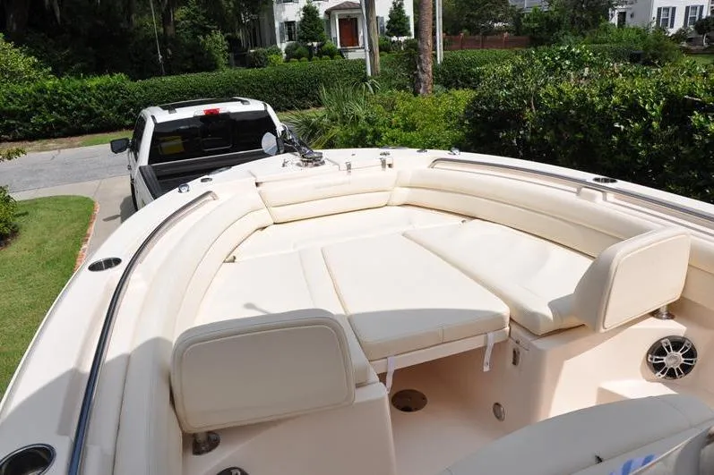 Slide: The Image of 2021 Grady-White Fisherman 236 boat with cushioned seating, parked on a driveway. - 35