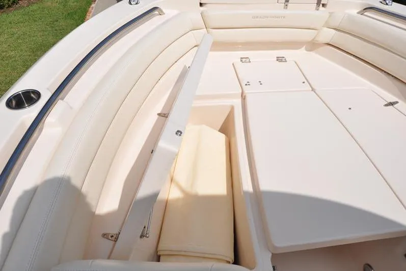 Slide: The Image of 2021 Grady-White Fisherman 236 boat interior with cushioned seating and storage compartment. - 36