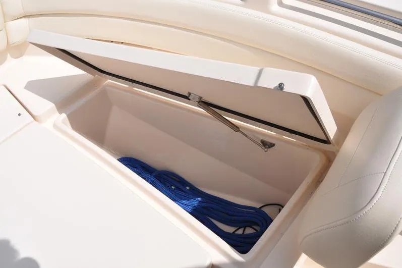 Slide: The Image of Storage compartment on 2021 Grady-White Fisherman 236 boat with blue rope inside. - 37