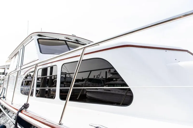 Slide: The Image of 2008 Huckins Linwood yacht with sleek white exterior and tinted windows. - 14