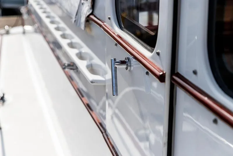 Slide: The Image of Close-up of a 2008 Huckins Linwood boat handle and window detail. - 15