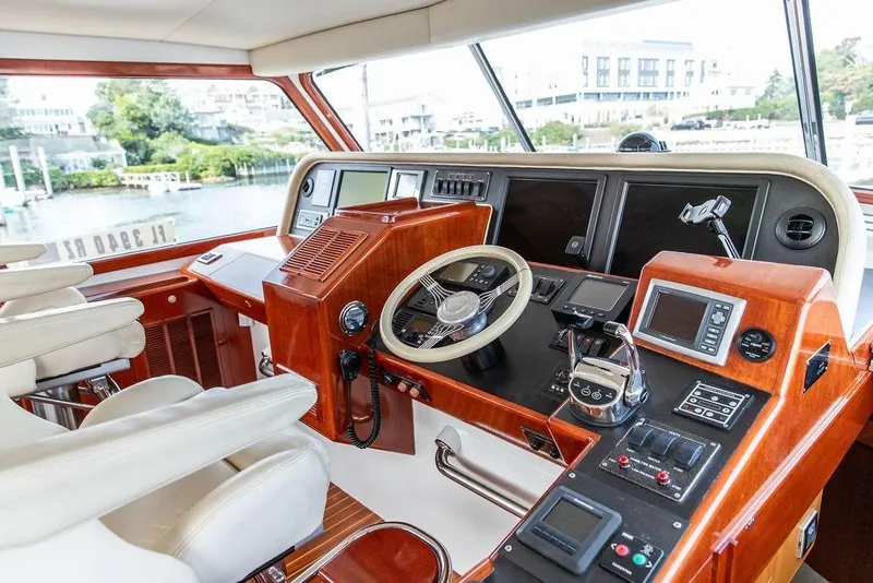 Slide: The Image of 2008 Huckins Linwood yacht helm with modern navigation equipment and luxurious seating. - 19