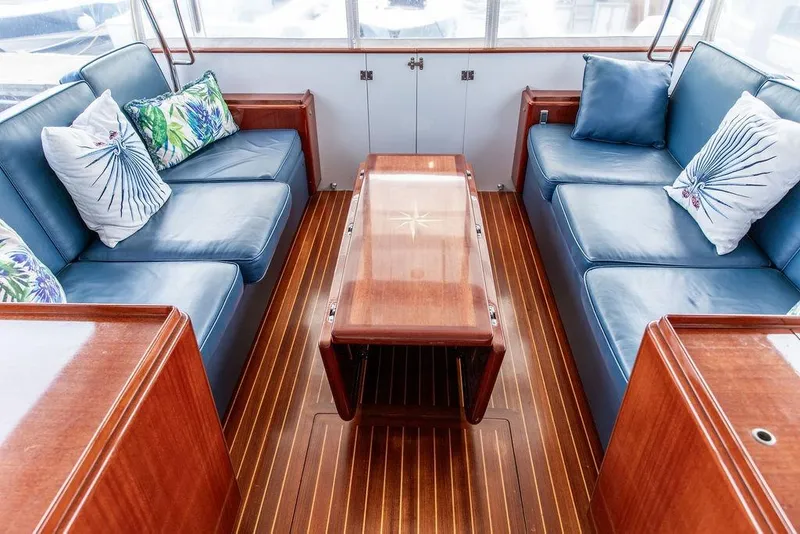 Slide: The Image of Luxurious 2008 Huckins Linwood yacht interior with blue seating and decorative pillows. - 2