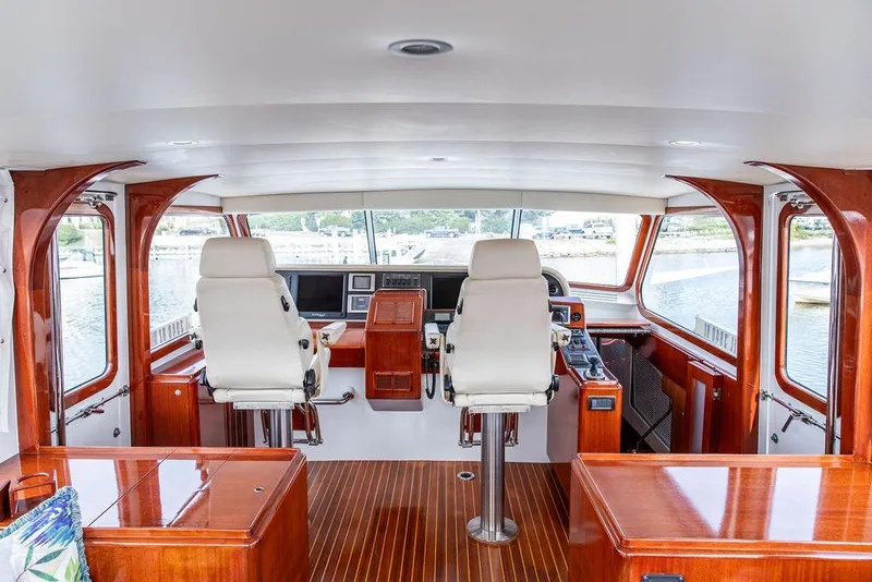 Slide: The Image of Interior of a 2008 Huckins Linwood yacht with elegant wood finish and dual captain chairs. - 22